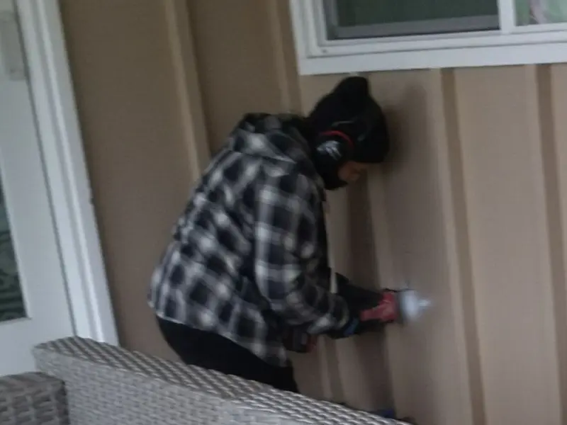Professional electrician installing an exterior outlet in Brush